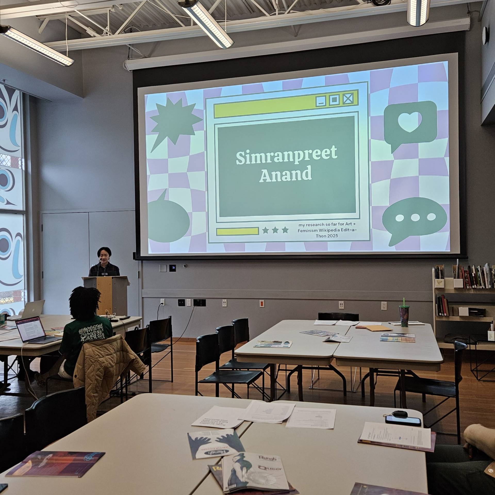 Diverse classroom with presentation on art and feminism at Rungh, featuring students engaging in cultural and social discussions.