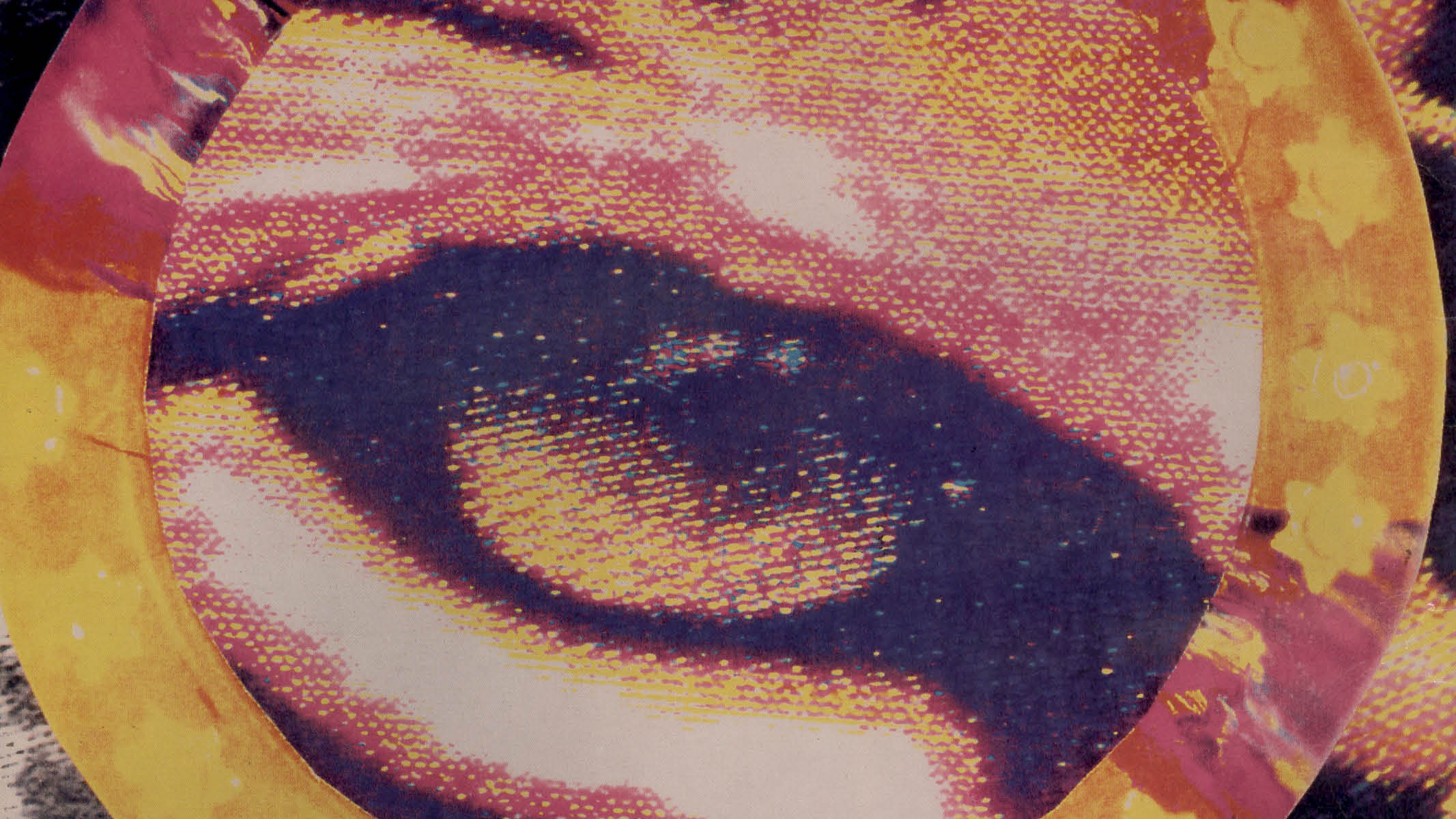Close-up of an artistic eye with bold colors and pixelated design.