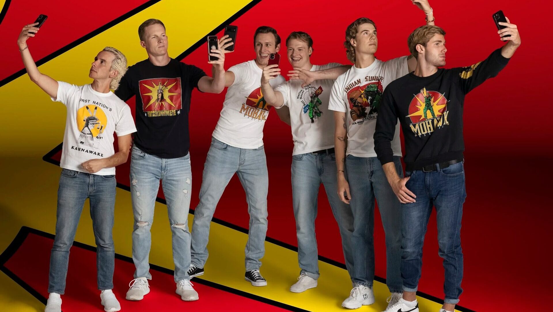 Group of young people taking selfies against a vibrant red and yellow abstract background.