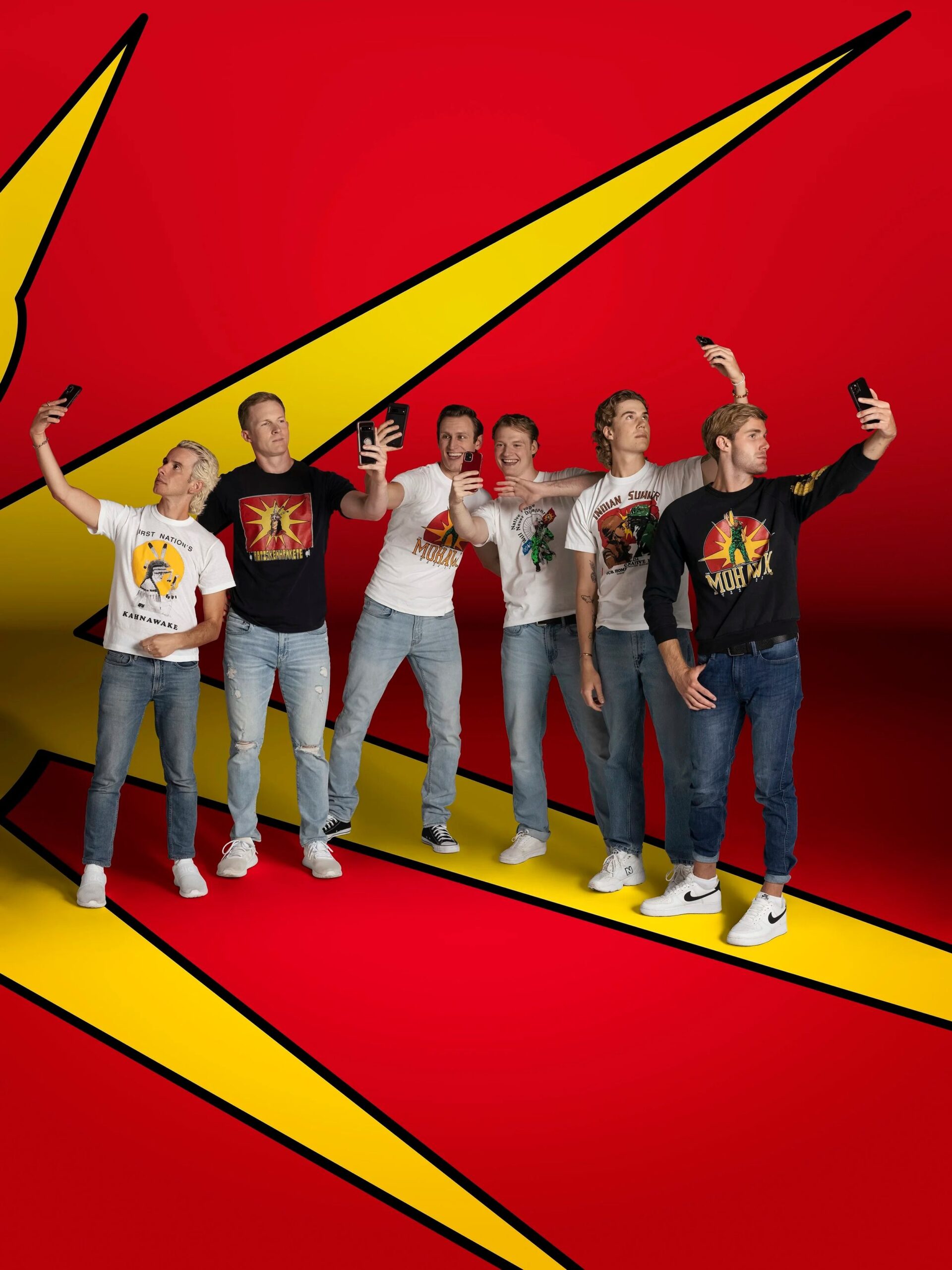Group of young people taking selfies against a vibrant red and yellow abstract background.
